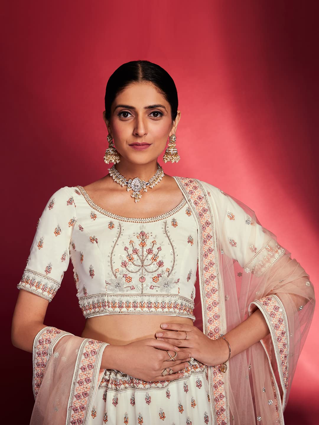 FUSIONIC This outfit is beautifully decorated intricately with sequin and zarkan. The White georgette lehenga will come with matching dupatta and blouse.