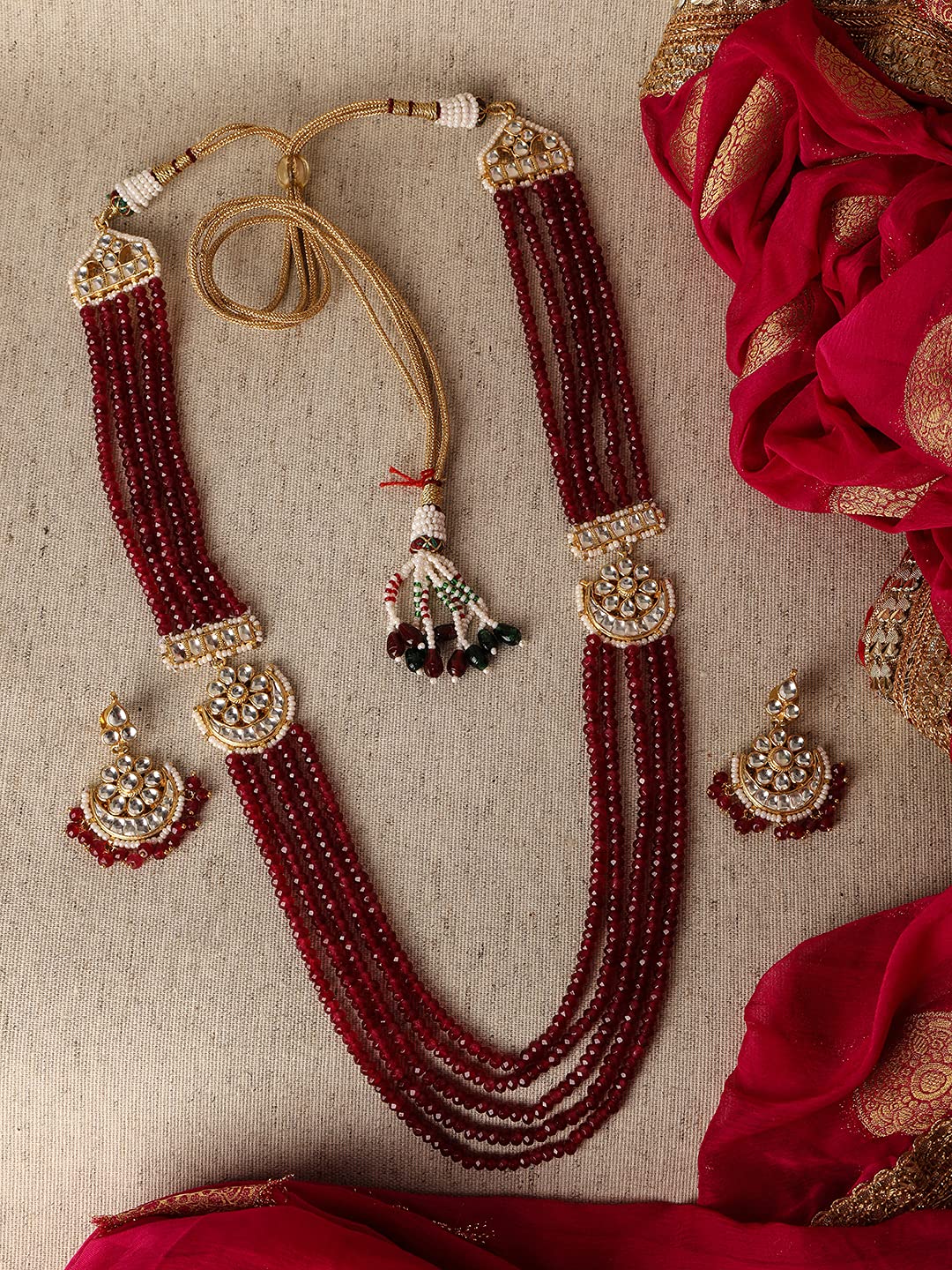 ACCESSHER Gold toned Ruby crystals and Handcrafted kundan and pearl embellished Jewellery set for women and girls set of 1
