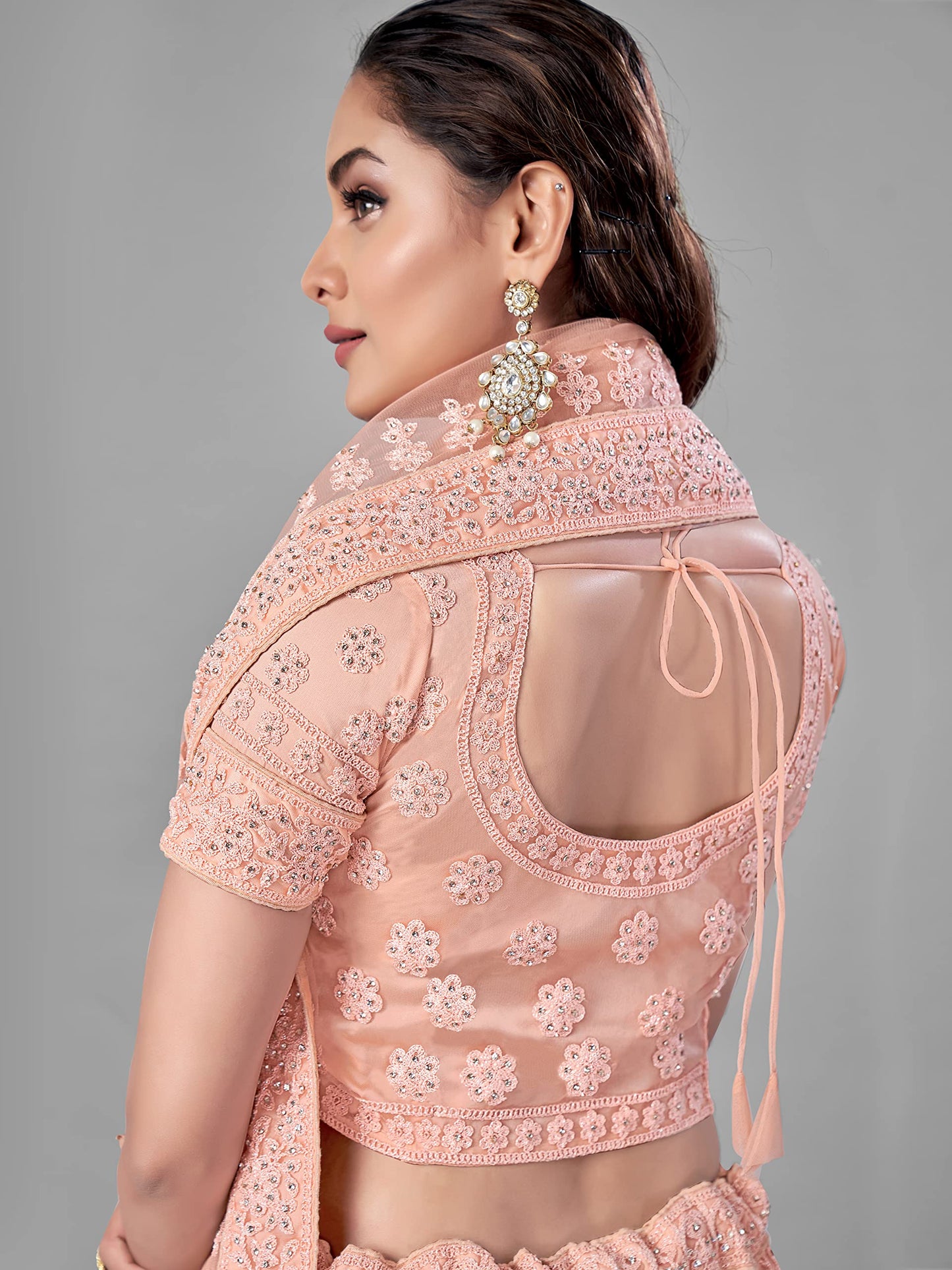 FUSIONIC Peach Color Soft Net Material Stone Work Lehenga Choli For Women